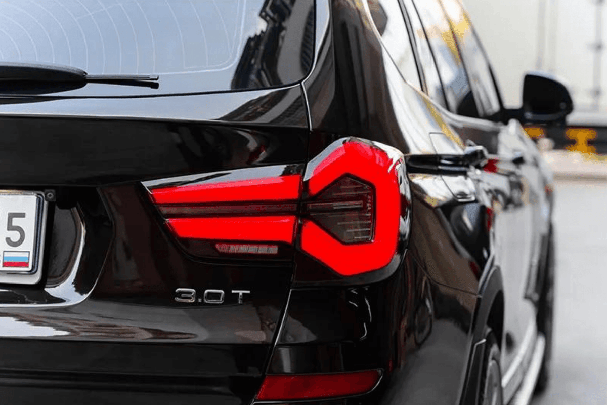 BMW F25 X3 LED tail lights by K2 Industries, next-generation LCI style, installed on the 2010-2017 vehicle with sleek design.