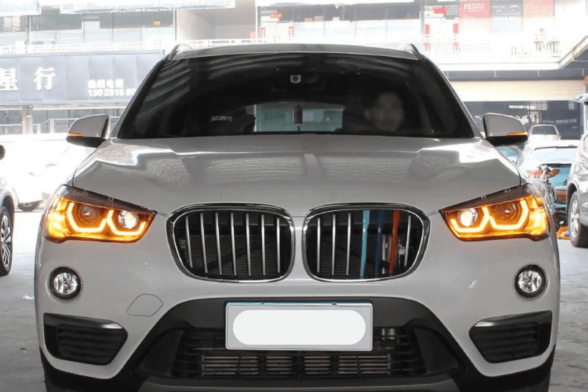 BMW F48 X1 modern style headlights upgrade by K2 Industries, showing sleek daytime running lights and detailed headlight design.