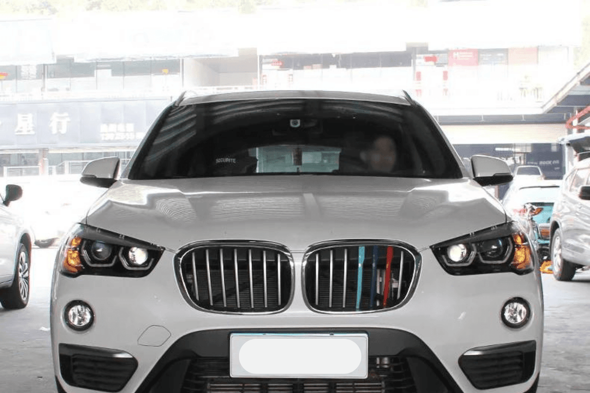 BMW F48 X1 modern style headlights upgrade by K2 Industries, showing sleek headlight assembly with LED daytime running lights.