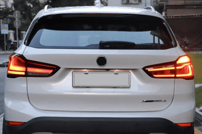 BMW F48 X1 tail light update by K2 Industries, red and smoked variants, for models 2016-2022, showing front and side views.