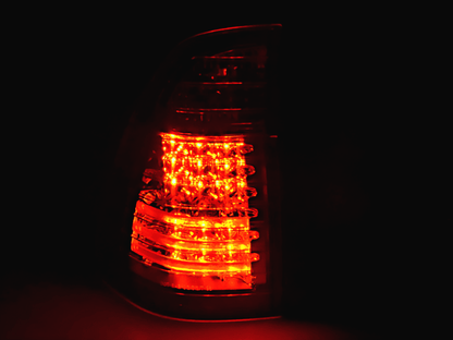 BMW X5 E53 black and clear LED tail lights by K2 Industries, compatible with 1998-2002 models, showing close-up of illuminated lights.