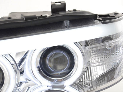 BMW X5 E53 headlights with CCFL chrome angel eyes and LED accents by K2 Industries for 2003-2006 models.