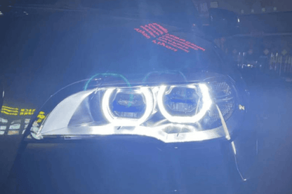 BMW X5 E70 OE Style Angel Eyes projector headlight by K2 Industries, showing the sleek design and bright lighting elements.