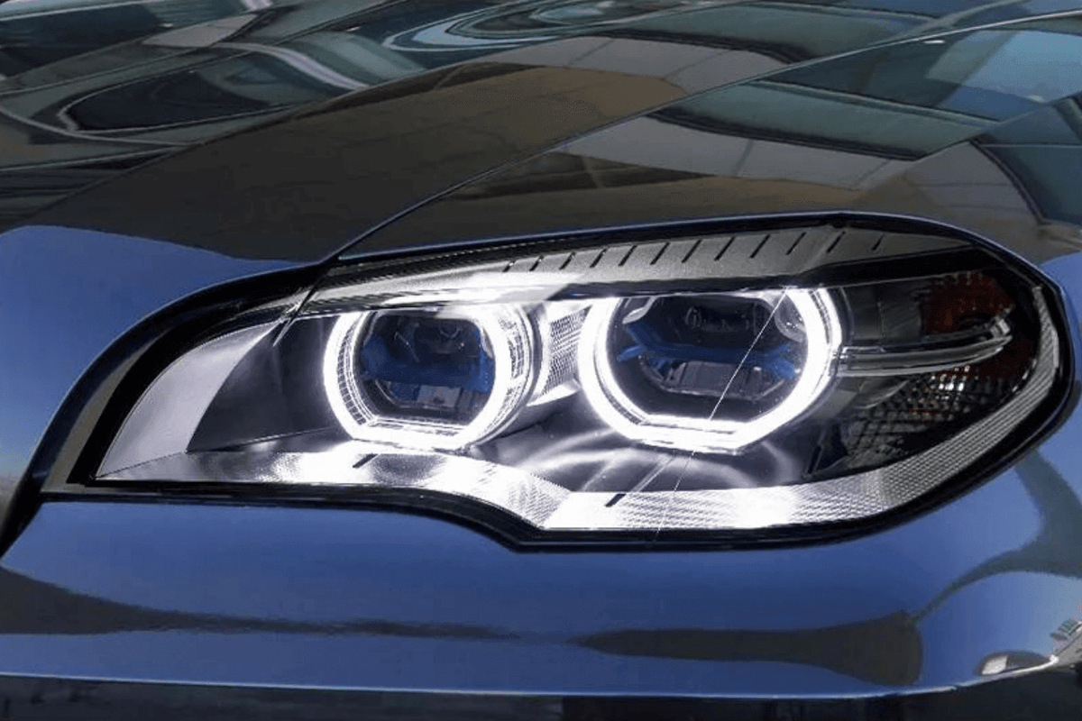 BMW X5 E70 projector headlights with OE style angel eyes from K2 Industries, showcasing sleek design for models 2007-2013.