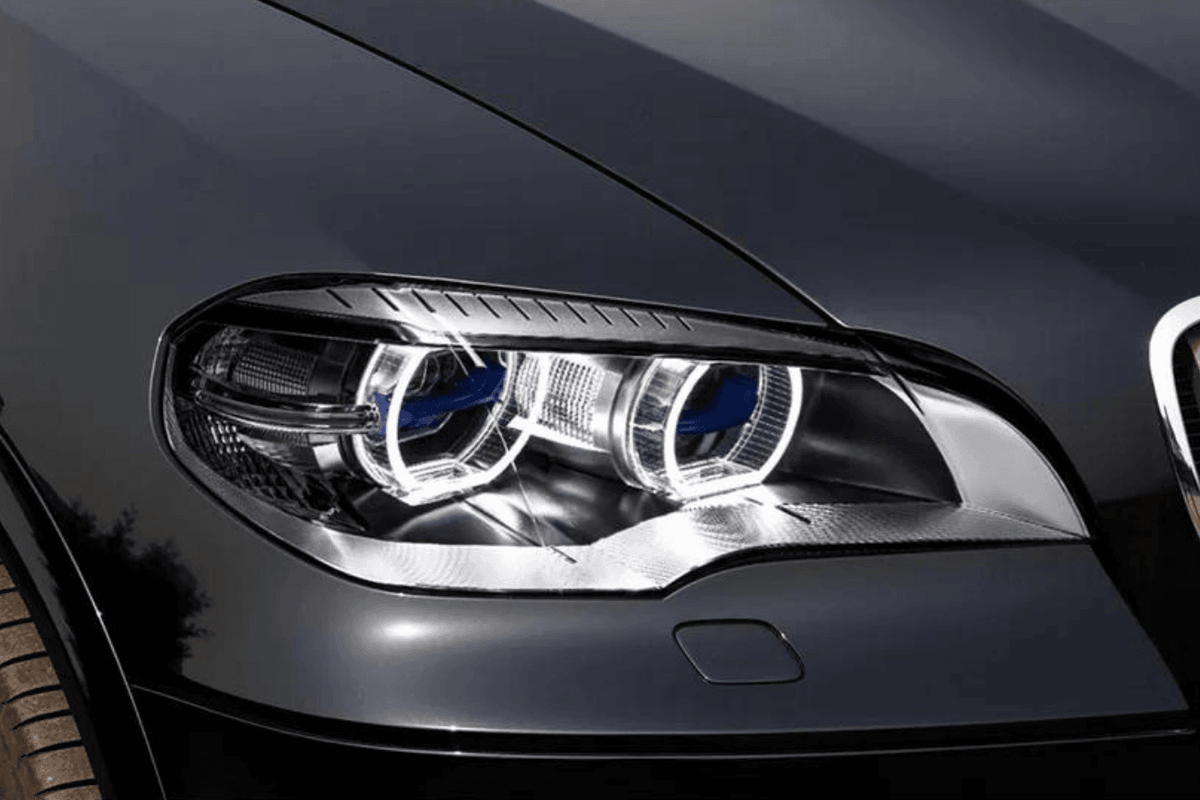 BMW X5 E70 projector headlights with OE style angel eyes, black housing, and clear lens for models 2007-2013 by K2 Industries