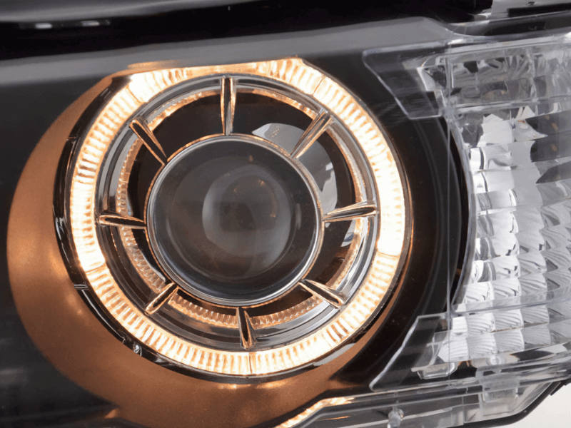 BMW X5 E53 black OE+ Angel Eyes headlights from K2 Industries, showing the front view with integrated angel eye rings.