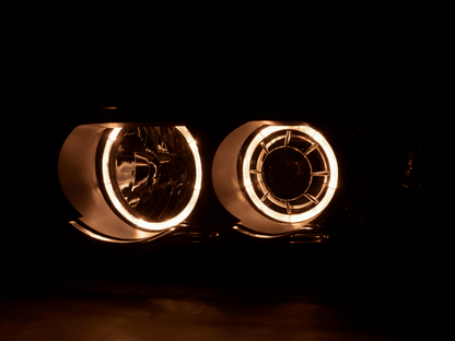 Black BMW X5 E53 headlights with OE+ angel eyes from K2 Industries, designed for 2000-2003 models, featuring clear lens and modern styling.
