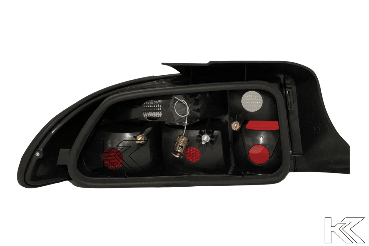 BMW Z3 OEM style smoked tail lights by K2 Industries, showing dark tinted lens covers on the rear of a 1990s BMW Z3.