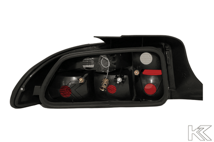BMW Z3 OEM style smoked tail lights by K2 Industries, showing dark tinted lens covers on the rear of a 1990s BMW Z3.