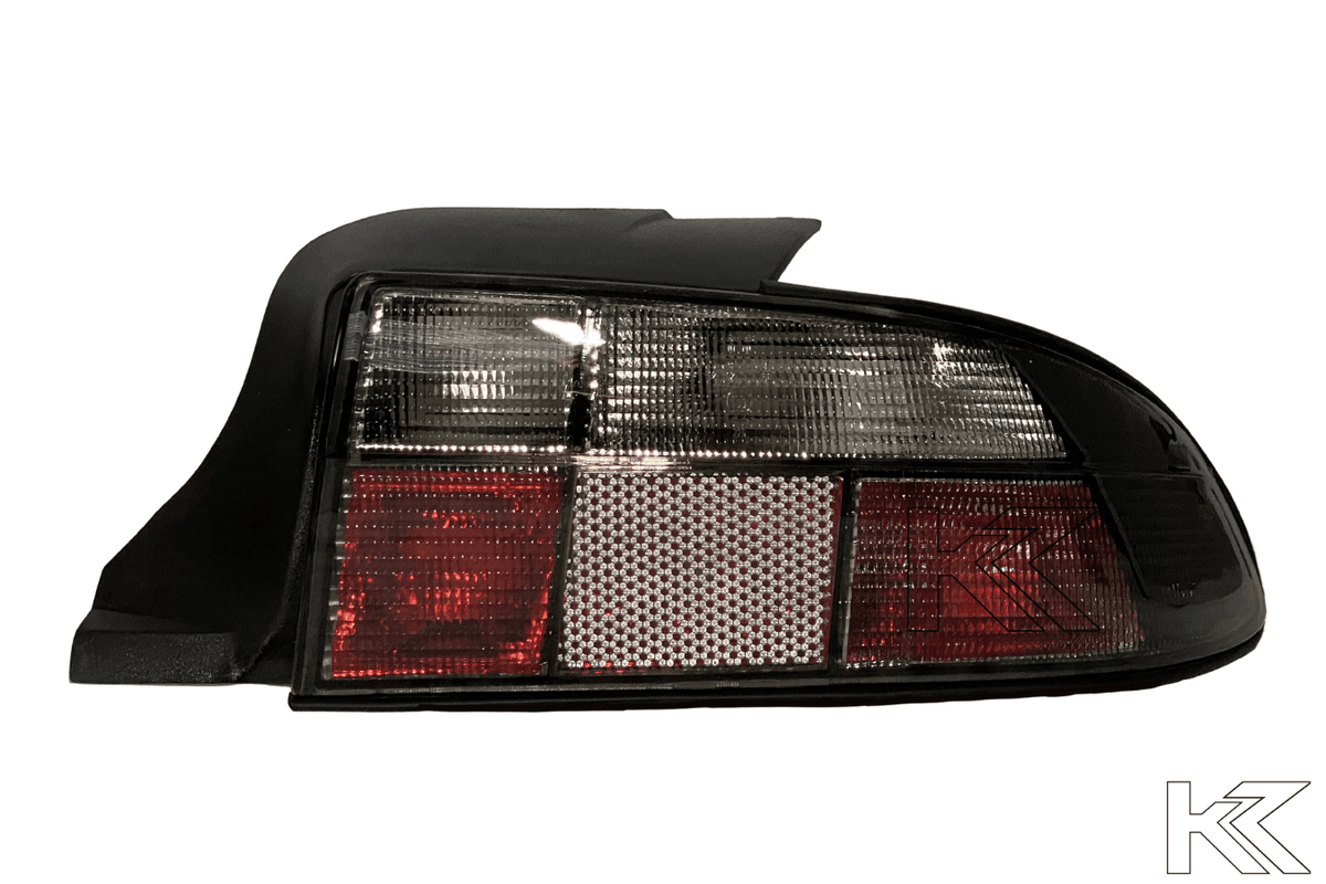 BMW Z3 OEM style smoked tail lights by K2 Industries, showing the sleek, tinted design with clear lenses and mounting details.