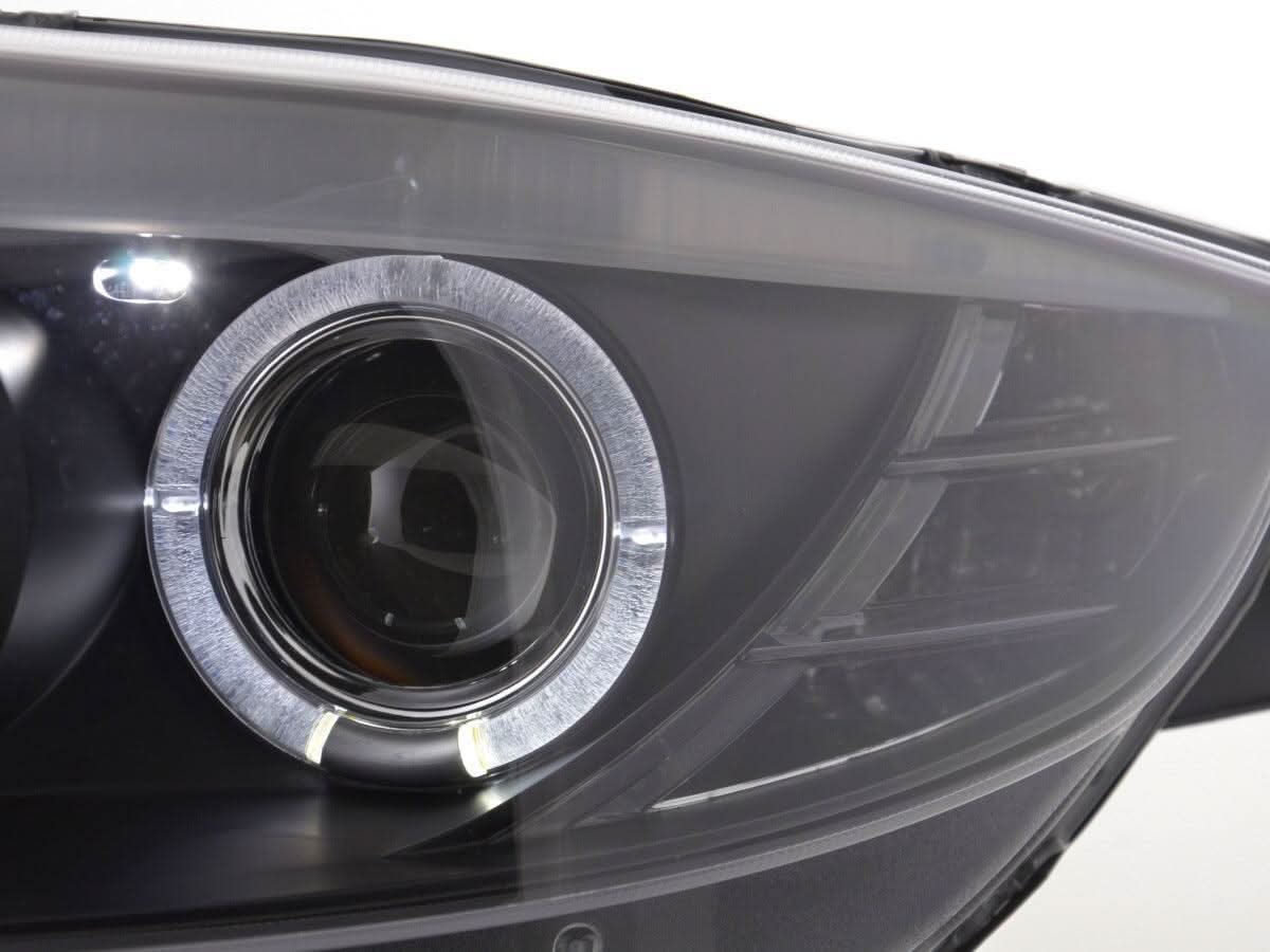 Black headlight set for BMW Z4 E85 E86 (2003-2008) by K2 Industries, featuring dual headlights with clear lenses and black housing.