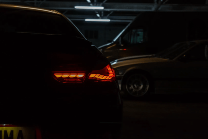 BMW 6 Series F12 F13 F06 smoke and red GTS OLED style tail lights by K2 Industries installed on a 2011-2018 model.