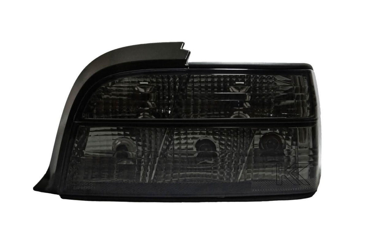 BMW E36 coupe smoked and clear tail lights by K2 Industries, showcasing sleek automotive tail light design for 1990-1999.