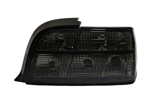BMW E36 coupe smoked and clear tail lights by K2 Industries, showcasing sleek automotive tail light design for 1990-1999.