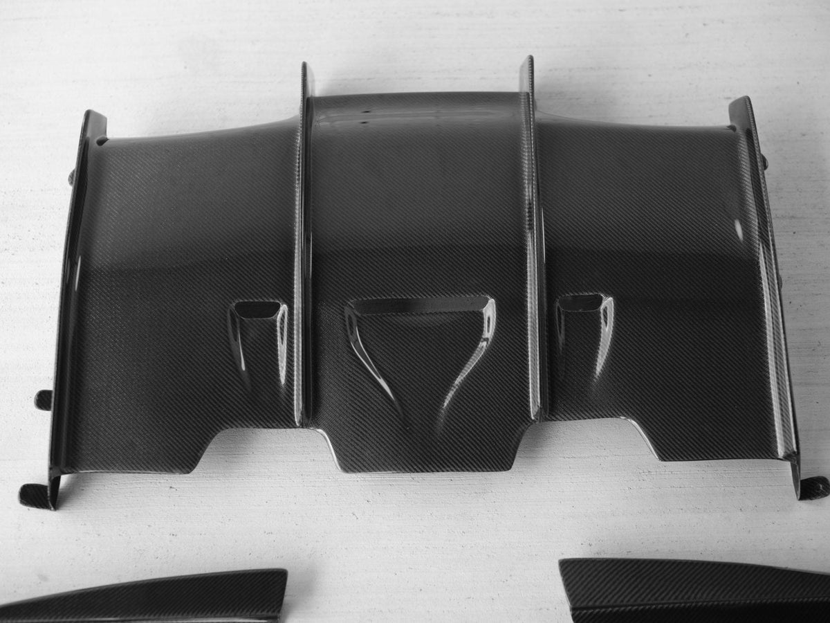 BMW F80 M3 and F82/F83 M4 carbon fiber rear diffuser by Palenon Performance, showcasing sleek, aerodynamic design.