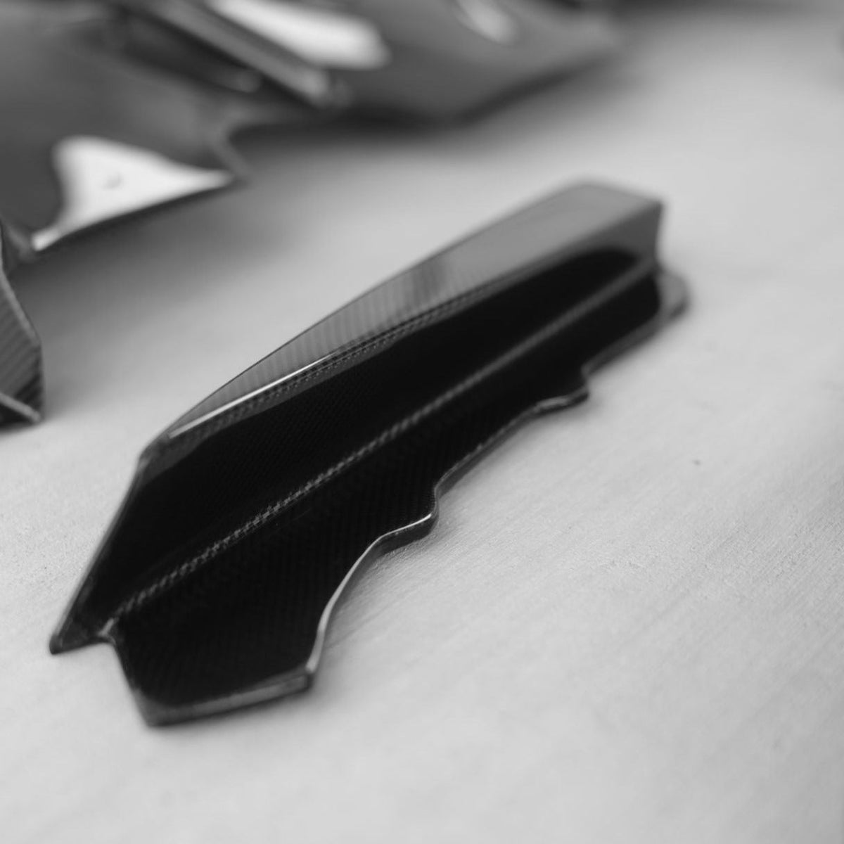 BMW F80 M3 and F82/F83 M4 carbon fiber rear diffuser by Palenon Performance, showcasing sleek aerodynamic design.