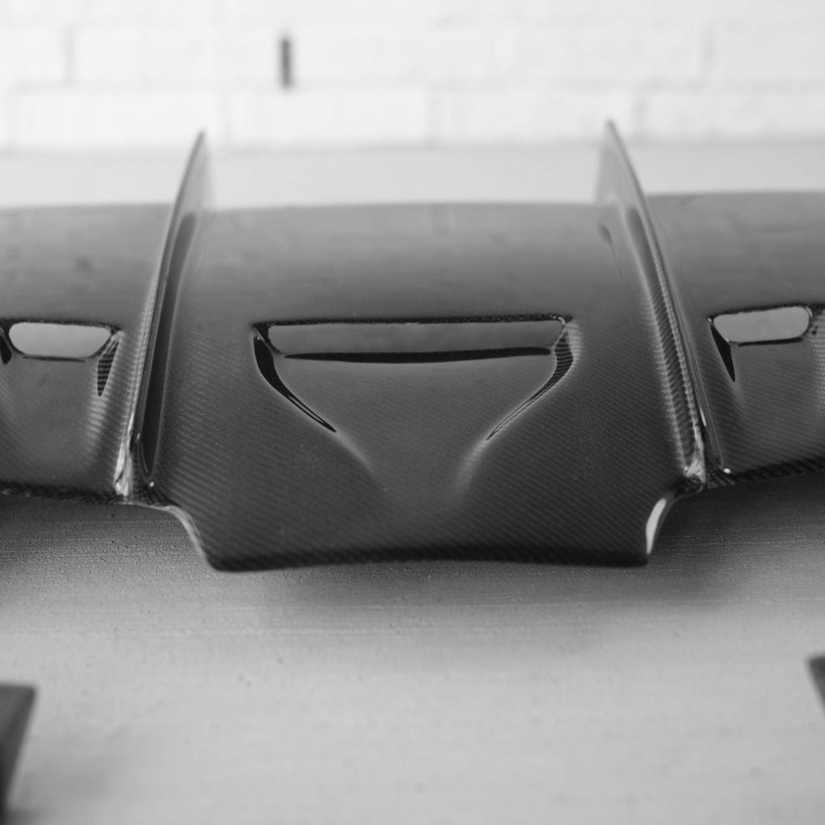BMW F80 M3 and F82/F83 M4 carbon fiber rear diffuser by Palenon Performance, showcasing sleek aerodynamic design.