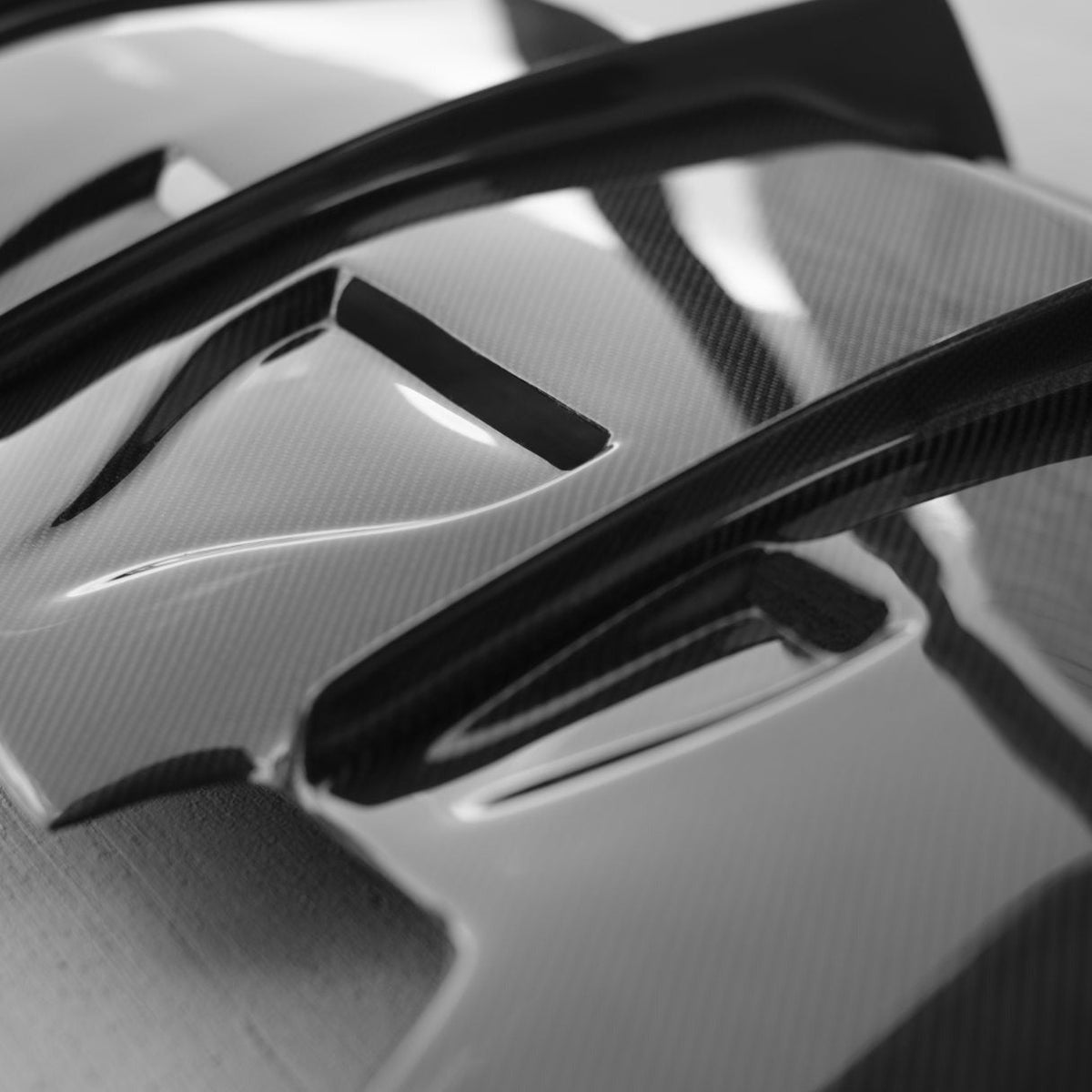 Carbon fiber rear diffuser for BMW F80 M3 and F82/F83 M4, by Palenon Performance, shown on a sleek sports car.