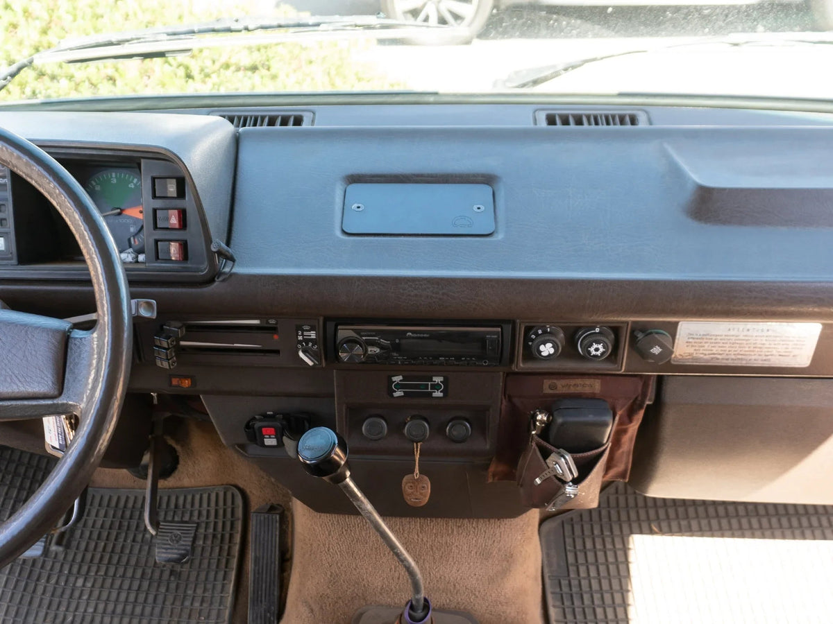 GoWesty Vanagon Ashtray Delete Kit front view showing sleek, custom black panel replacing the original ashtray in the vehicle interior.