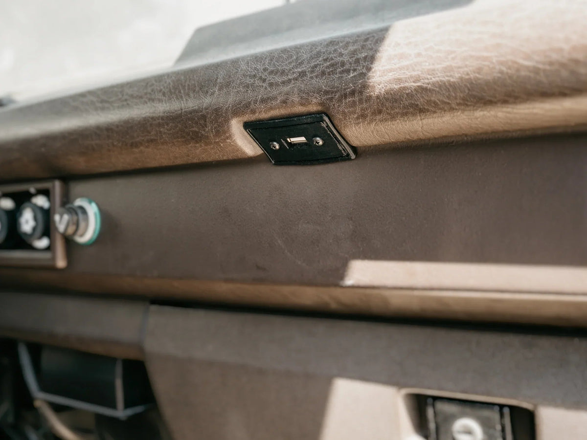GoWesty USB charging port conversion for map light, showing the compact device installed in vehicle interior.