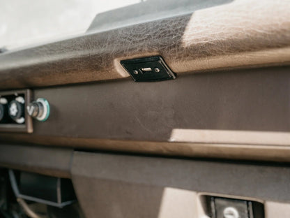 GoWesty USB charging port conversion for map light, showing the compact device installed in vehicle interior.