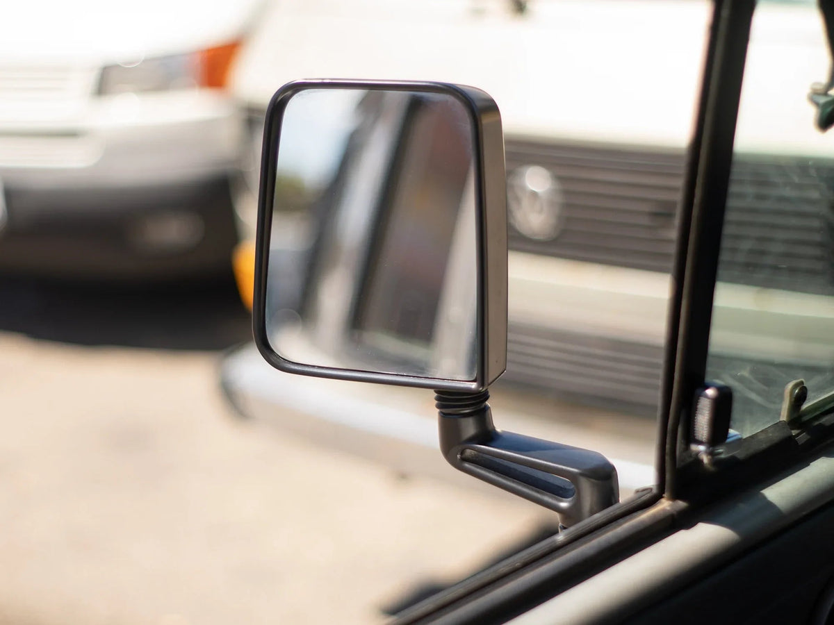 GoWesty Deluxe Manual Mirror Kit for Vanagon showing finished mirrors with black frames and mounting hardware on vehicle doors.