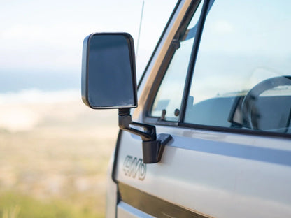 GoWesty Deluxe Manual Mirror Kit for Vanagon, featuring durable black mirror housing and adjustable manual mirror glass.
