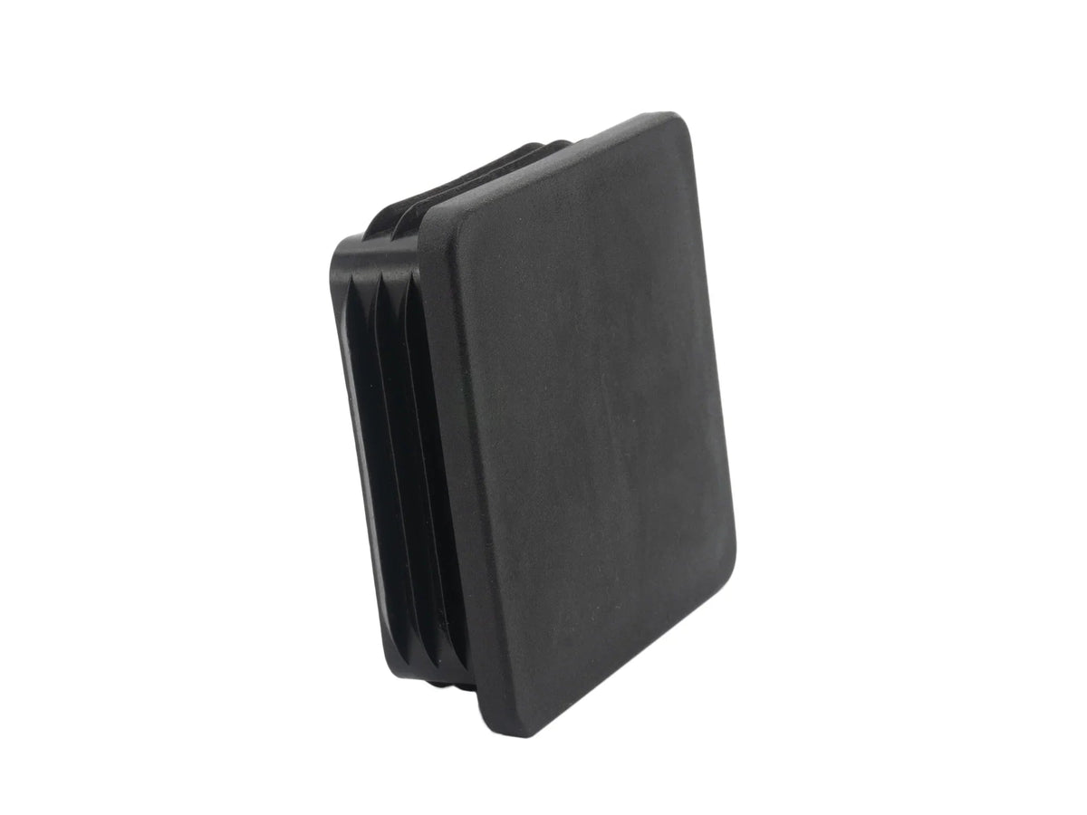Black square snap-in hitch hole cap by GoWesty, designed to cover and protect trailer hitch openings.