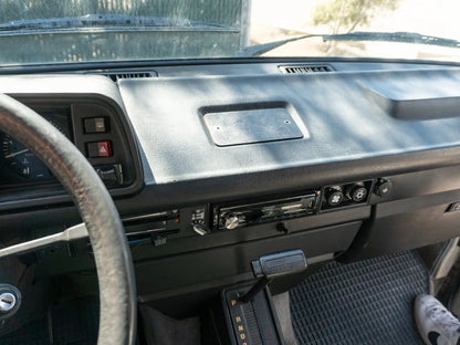 GoWesty Vanagon front ashtray delete kit showing black plastic cover with mounting hardware for interior upgrade