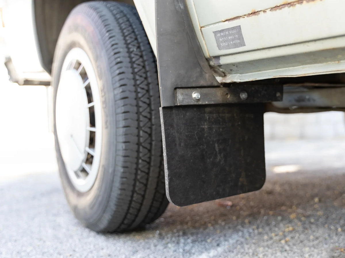 GoWesty Vanagon mud flap repair kit with tools and parts for replacing and fixing mud flaps on a vehicle.