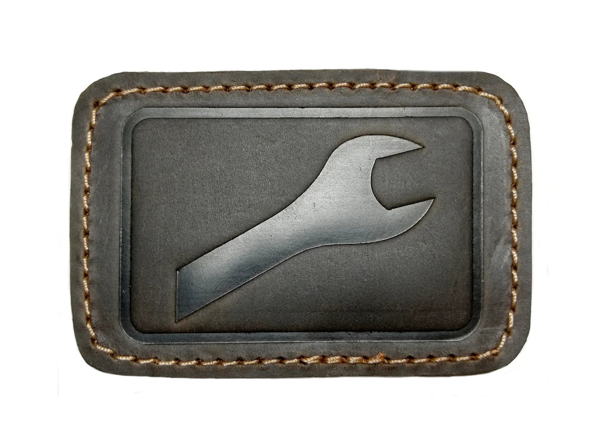 Leather patches for GoWesty combi bags, showing close-up of textured brown leather repair patches on bag surface.