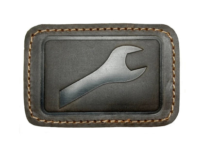 Leather patches for GoWesty combi bags, showing close-up of textured brown leather repair patches on bag surface.
