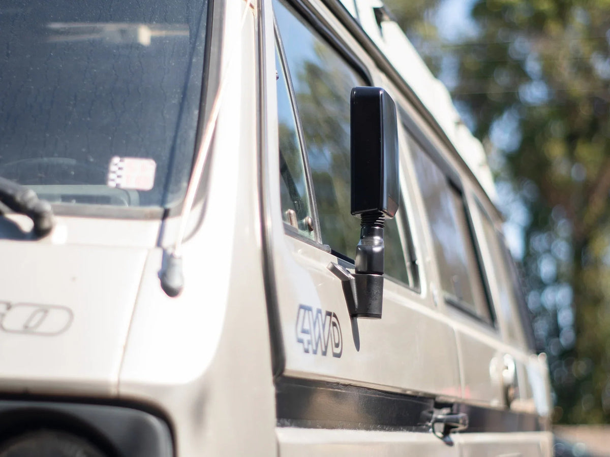 GoWesty Deluxe Manual Mirror Kit for Vanagon, featuring two side mirrors with black mounting arms and adjustable glass.