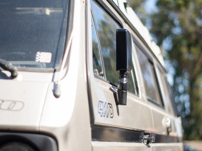 GoWesty Deluxe Manual Mirror Kit for Vanagon, featuring two side mirrors with black mounting arms and adjustable glass.