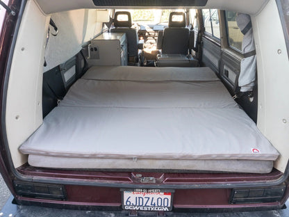 GoWesty slip-cover for large mattress topper, soft fabric protective cover showing a snug fit over the topper in a bedroom setting.