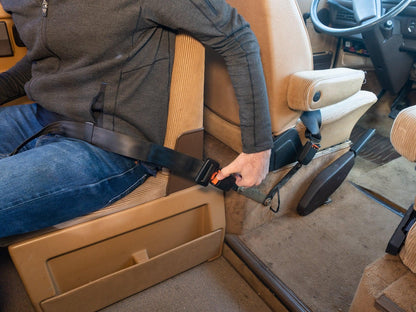 GoWesty seat belt receiver extension kit showing a close-up of the black extension device attached to a vehicle seat belt.