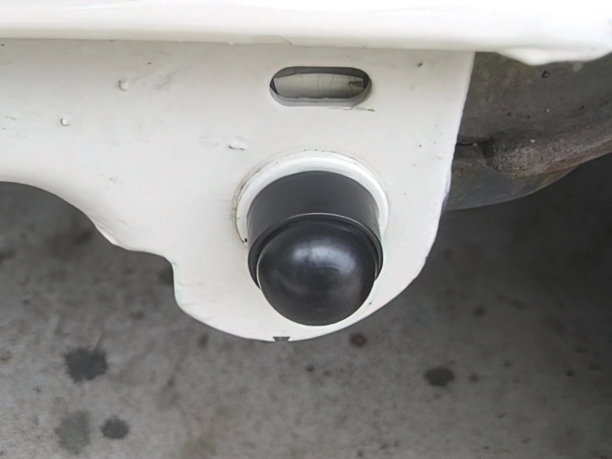 Pair of GoWesty pivot bolt caps for Vanagon rear suspension, showing the black protective caps installed on suspension components.