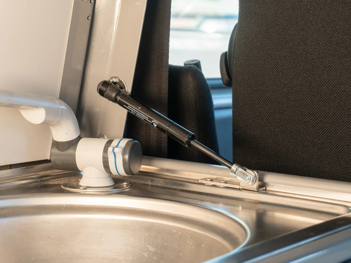 GoWesty Stove Lid Gas Strut Conversion Kit for Vanagon, supporting an open stove lid