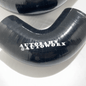 Autobahn Autoworx 90-degree elbow hoses in a hose kit, showing flexible rubber hoses with metal fittings for automotive use.