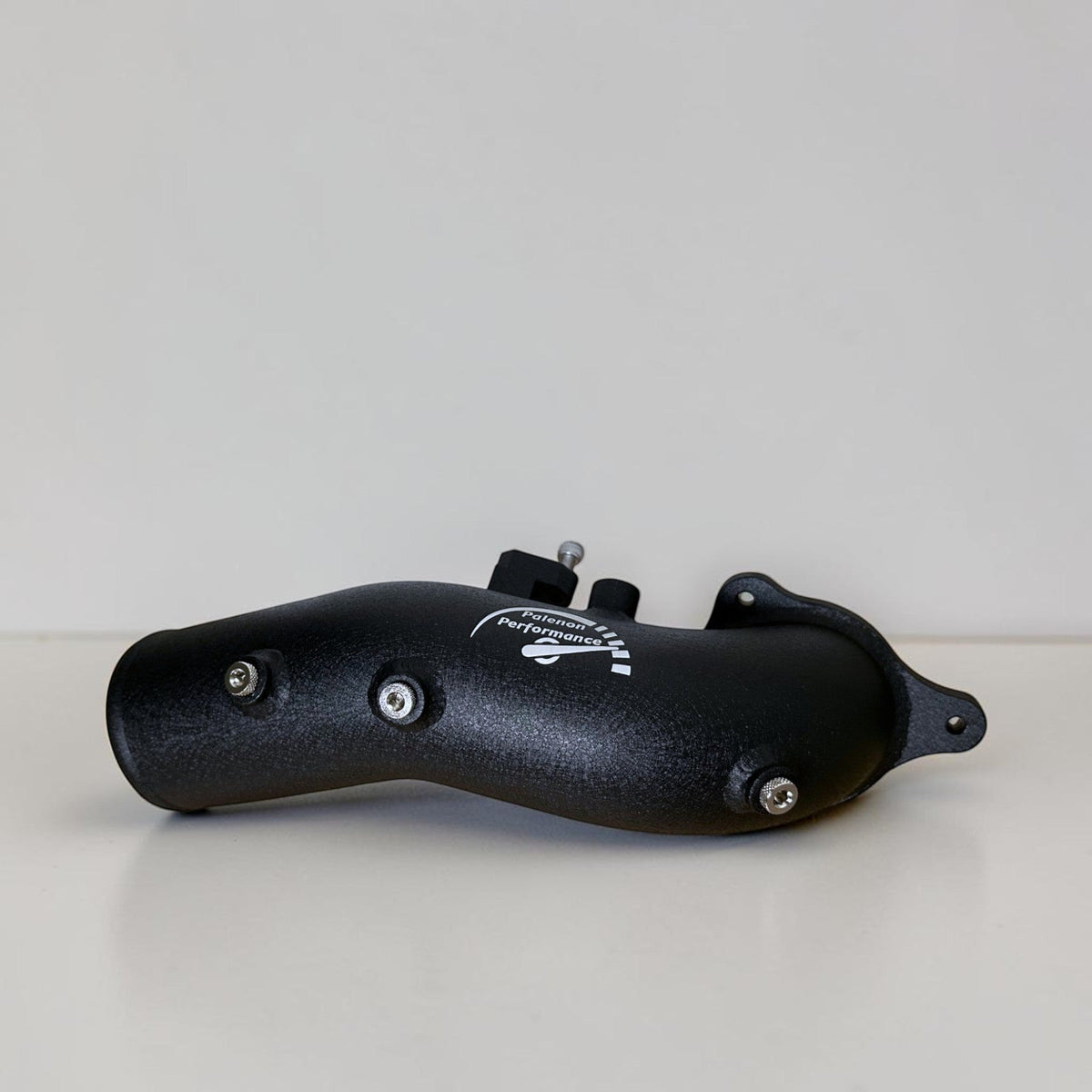 Black Palenon Performance B58 charge pipe for BMW and Supra models, shown installed with smooth finish and precise fit.