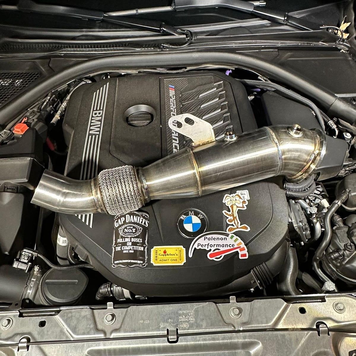 Palenon Performance B58 Racing Downpipe for BMW and Supra, showing the metallic downpipe with logo and mounting flanges.