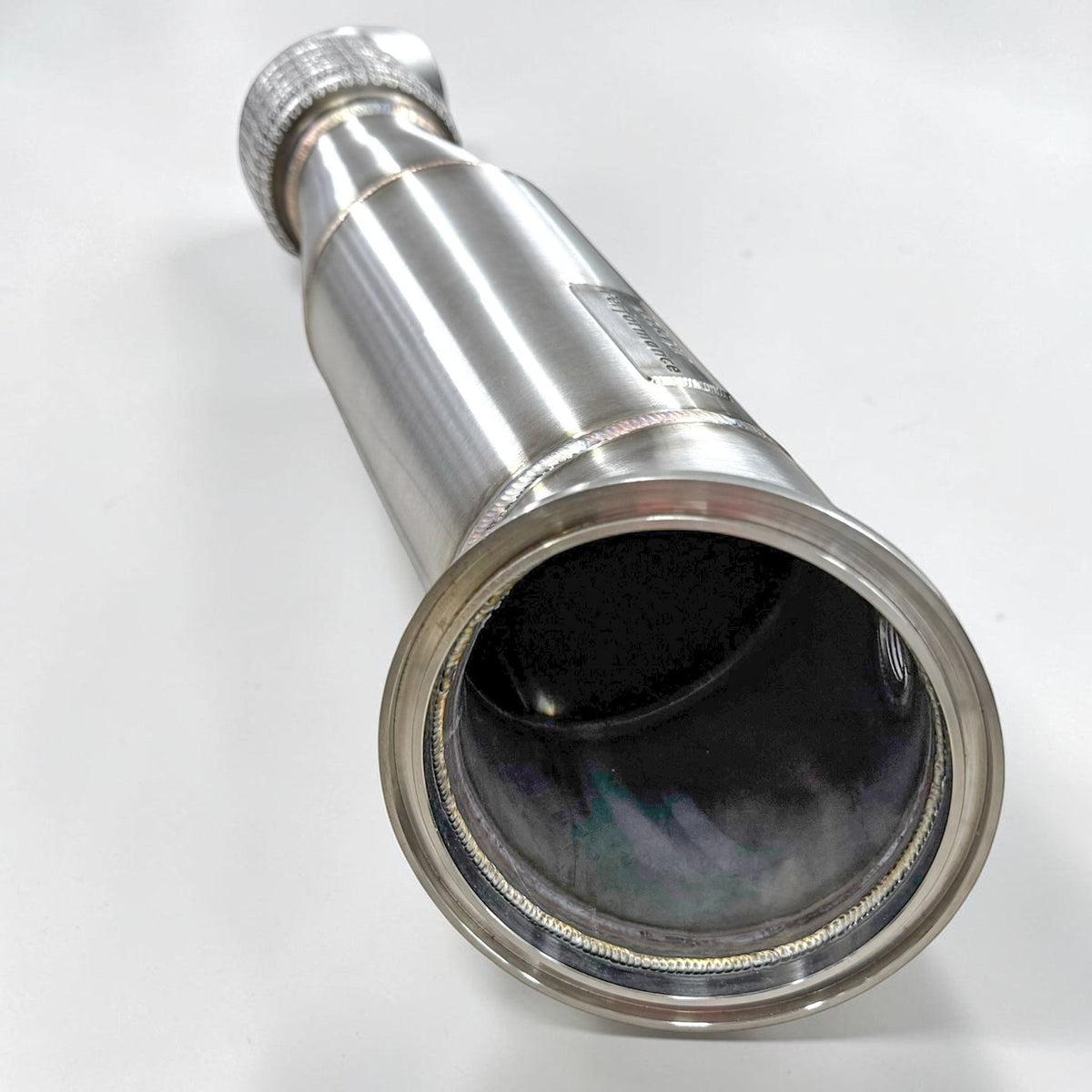 Palenon Performance B58 Racing Downpipe for BMW, featuring a sleek metal pipe with mounting flanges and exhaust connectors.