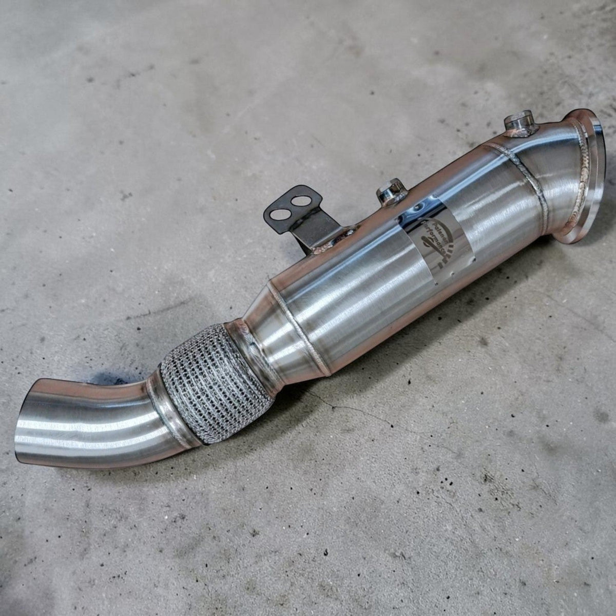 Palenon Performance B58 racing downpipe for BMW and Toyota Supra, showing the stainless steel exhaust component with flanges and welds.