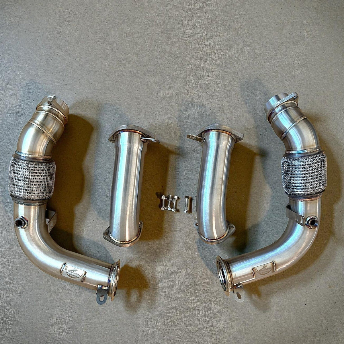Palenon Performance S68 Racing Downpipes for BMW G90 G99 M5, showing polished stainless steel construction and connection points.