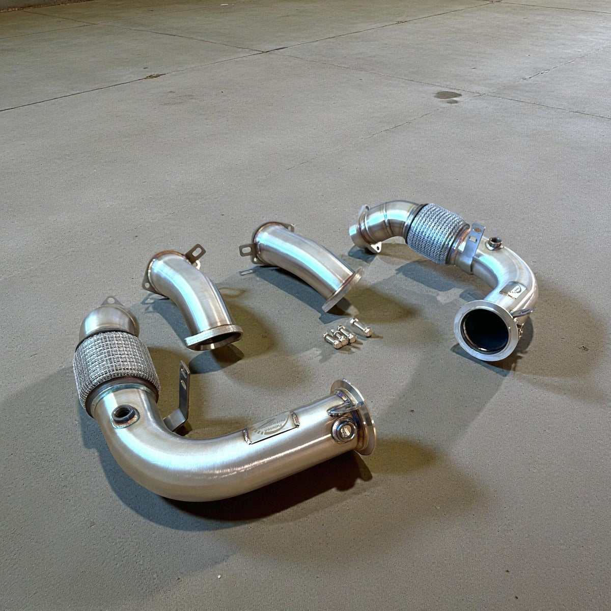 Palenon Performance racing downpipes for BMW G90 G99 M5, metal exhaust components with brand logo visible.