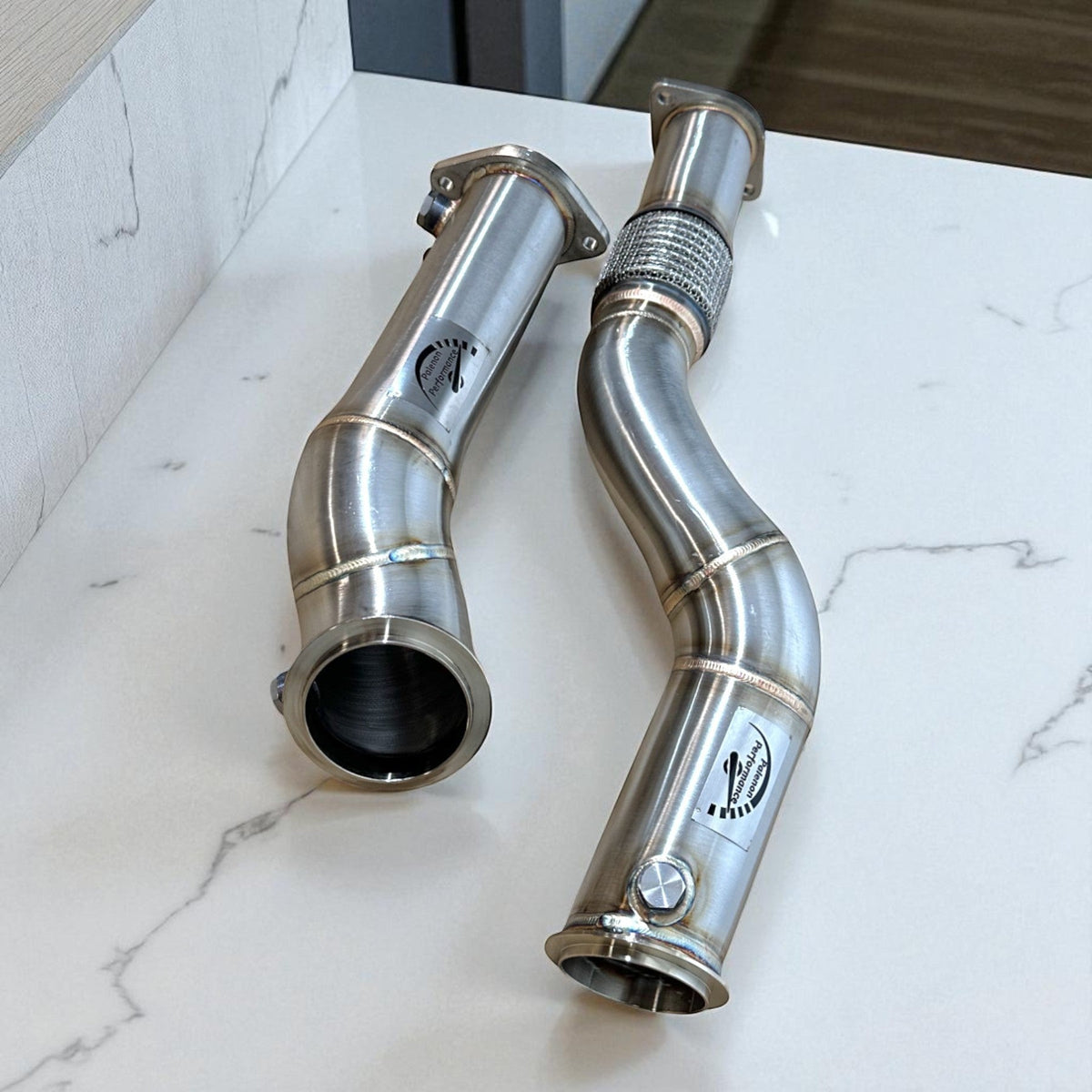 Stainless steel High Flow S58 Race Downpipe for BMW M3 G80, M2 G87, M4 G82 G83 by Palenon Performance, showing the sleek pipe design.