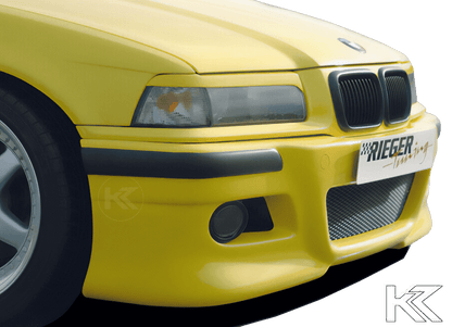K2 Industries BMW E36 front bumper in E46 style, showing the sleek black plastic bumper with mounting points and aerodynamic design