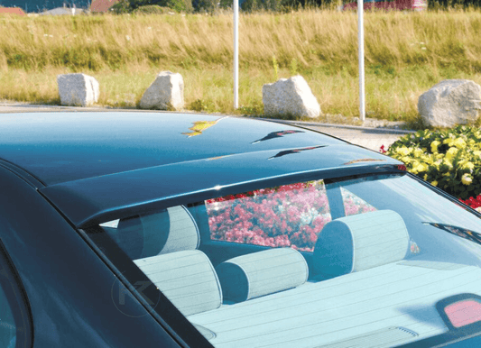 Black rear window cover for BMW E36 Sedan by K2 Industries, made of durable material, fits snugly over the rear window.