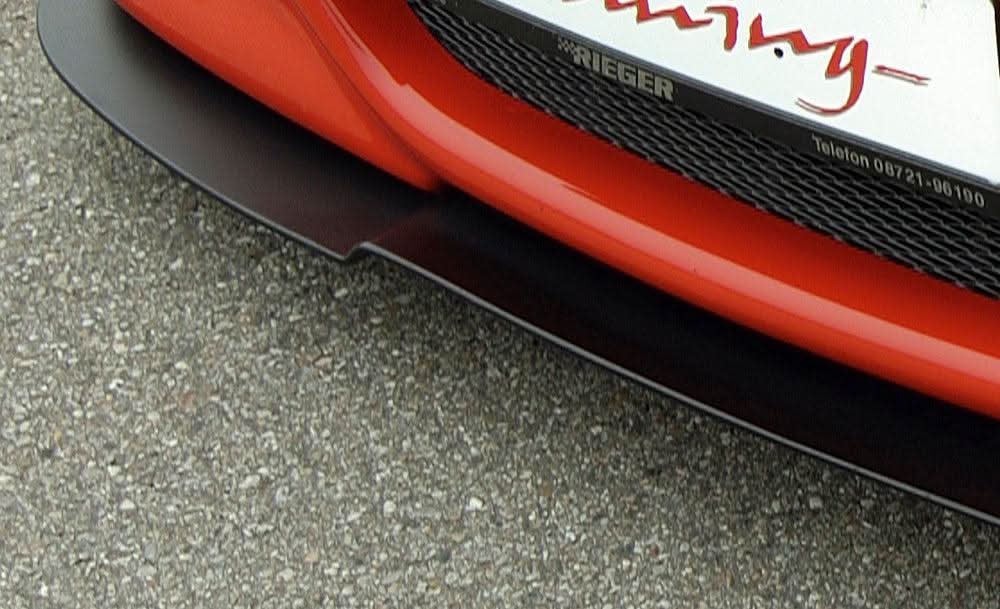 K2 Industries BMW E46 front splitter for Rieger front lip, aerodynamic car accessory, shown installed on vehicle.